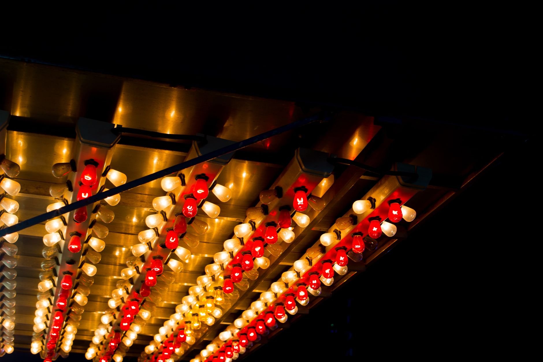 Colorful carousel lights glowing against a dark night sky